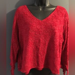 Woman’s red lace over red top with butterfly sleeves